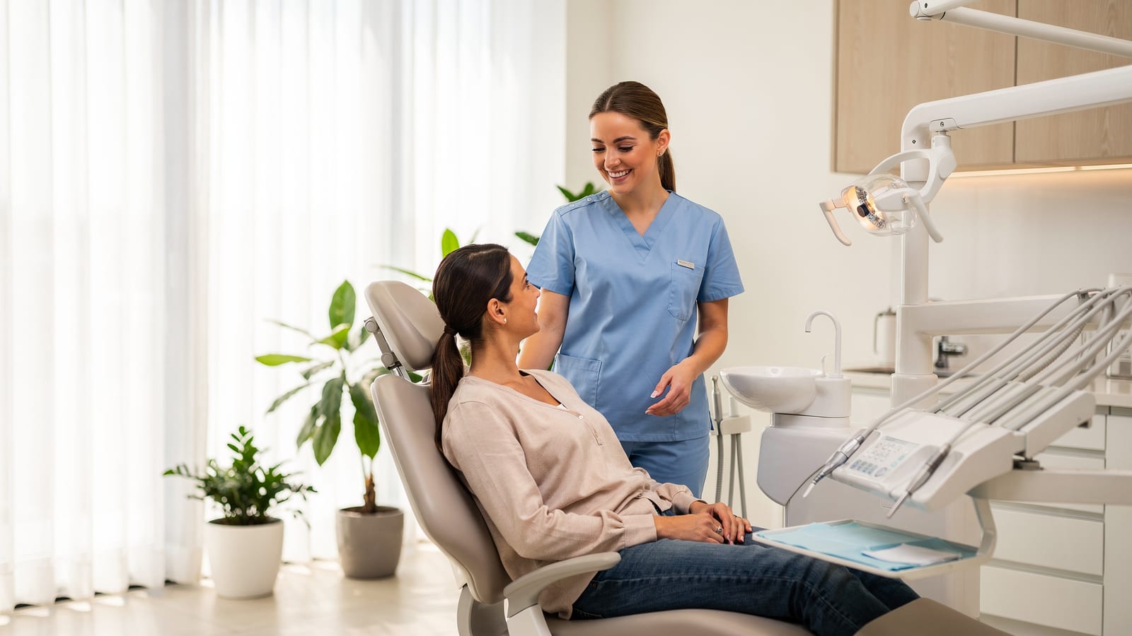 A calm, light-filled treatment room at Cedarwood Family Dental with a sage-green chair